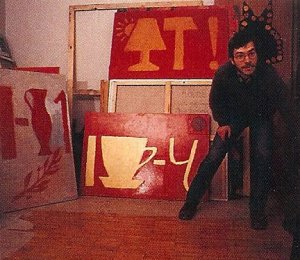 Andrei Roiter with some of the rebus-like paintings that recall the alphabet charts of the Kindergarten