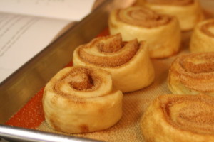 Easing the pain with a nice fresh batch of cinnamon rolls. Photo: Whitney. Source: Wikimedia Commons.