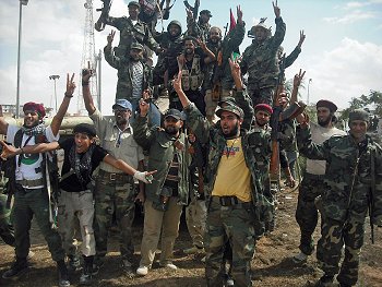 Fighters for Libya's interim government rejoice after winning control of the Qaddafi stronghold of Bani Walid. Photo: Magharebia. Source: Wikimedia Commons.