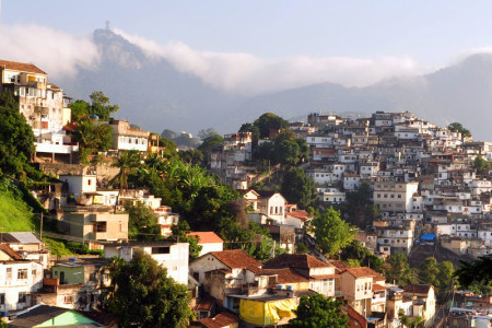 Rio de Janeiro favela (right, on hill), contrasted with a more affluent neighbourhood, as viewed from a tram in Santa Teresa. Photo: chansiyuan. Source: Wikimedia Commons.